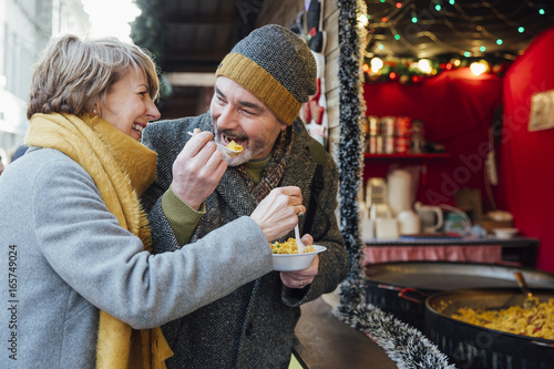 Elderly Couple Eating at Christmas Market