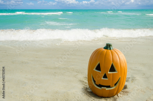 Halloween pumpkin background on the beach © ellensmile