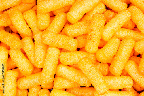 Cheese puffs puff as background texture pattern wallpaper.