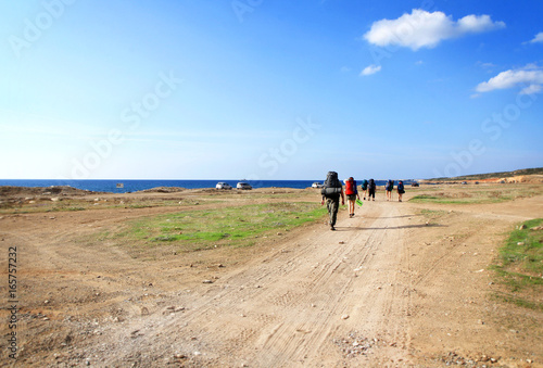 Backpackers on a sea shore background