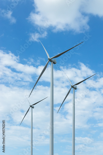 Wind turbine with cloud background on the sky.