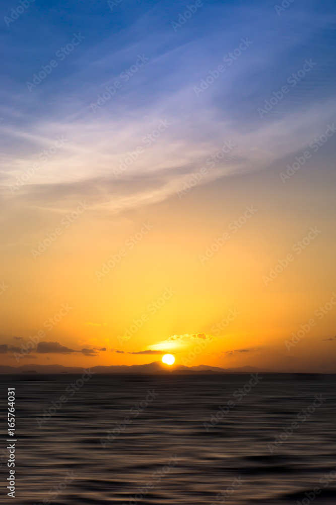 Naklejka premium Beautiful sunset at the lake with saturated sky and clouds. Idea: Un-focus image and use for background.