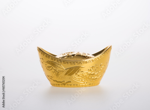 Gold or Chinese gold ingot mean symbols of wealth and prosperity on a background. photo