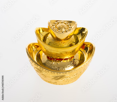 Gold or Chinese gold ingot mean symbols of wealth and prosperity on a background. photo