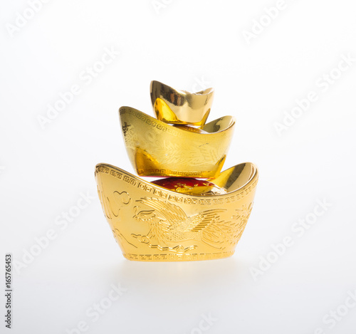 Gold or Chinese gold ingot mean symbols of wealth and prosperity on a background. photo