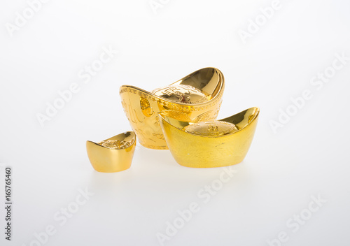 Gold or Chinese gold ingot mean symbols of wealth and prosperity on a background. photo