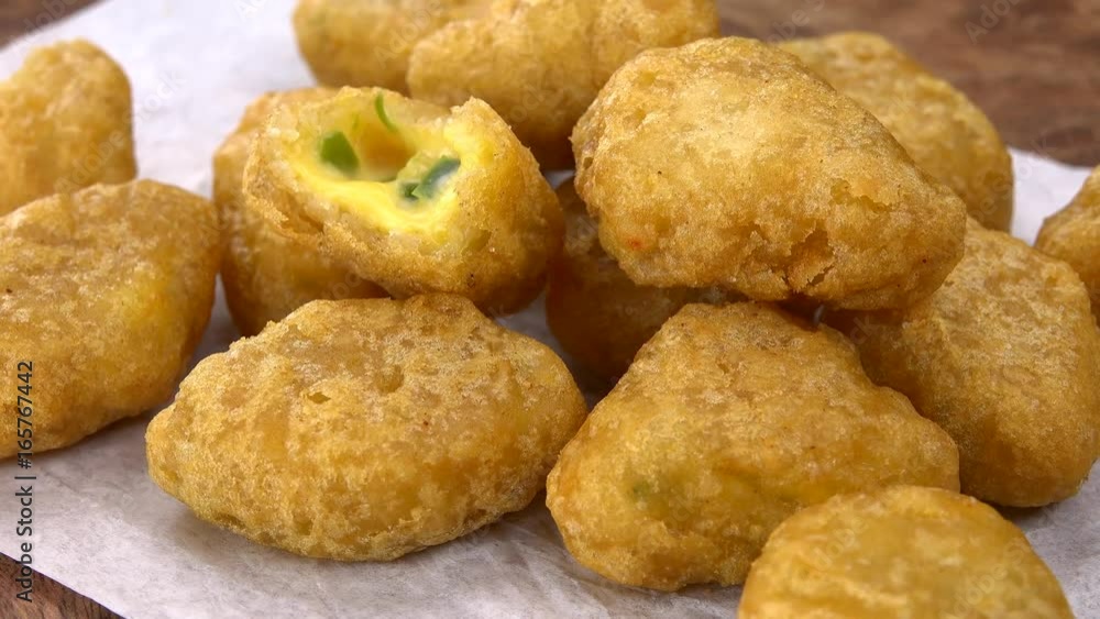 Cheese Nuggets (with Chilis) rotating on a wooden plate (not loopable; 4K) Cheese Nuggets (with Chilis) rotating on a wooden plate (not loopable; 4K)