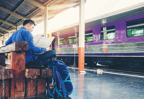Wallpaper Mural Tourist backpacker using map to travel at train station Torontodigital.ca