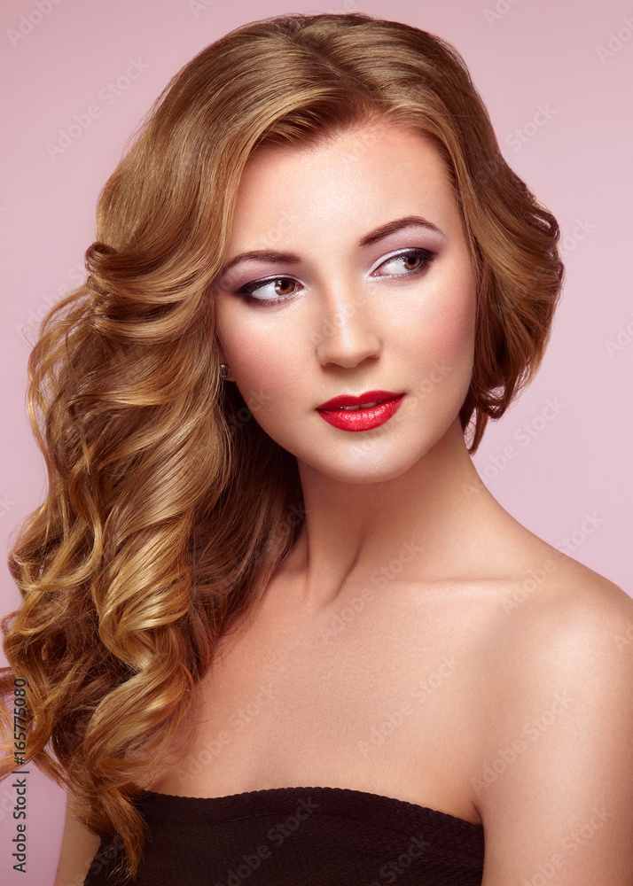 Blonde woman with long and volume shiny wavy hair . Beautiful model with curly hairstyle. Perfect make-up. Beauty style model Blonde woman with long and volume shiny wavy hair . Beautiful model with curly hairstyle. Perfect make-up. Beauty style model