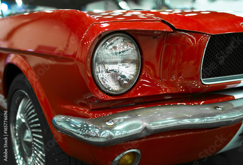 Front view of a old retro car. Car exterior details. Headlight of a retro car. The front lights of the car