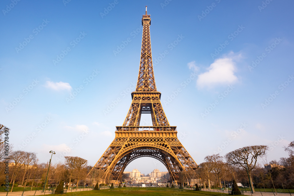 Eiffel tower against blue sky and white clouds in Paris, - morning light