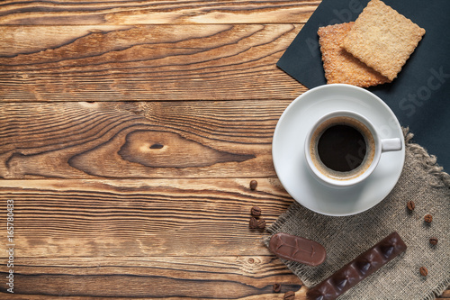 Coffee cup and cookie on wood