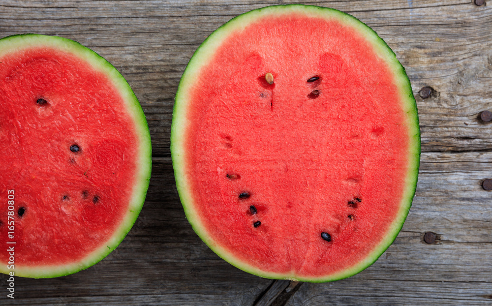 Half watermelons on a wooden table Half watermelons on a wooden table