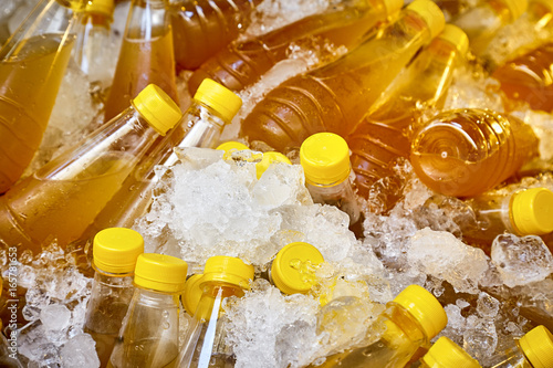 Sugarcane juice in plastic bottles chilled in ice