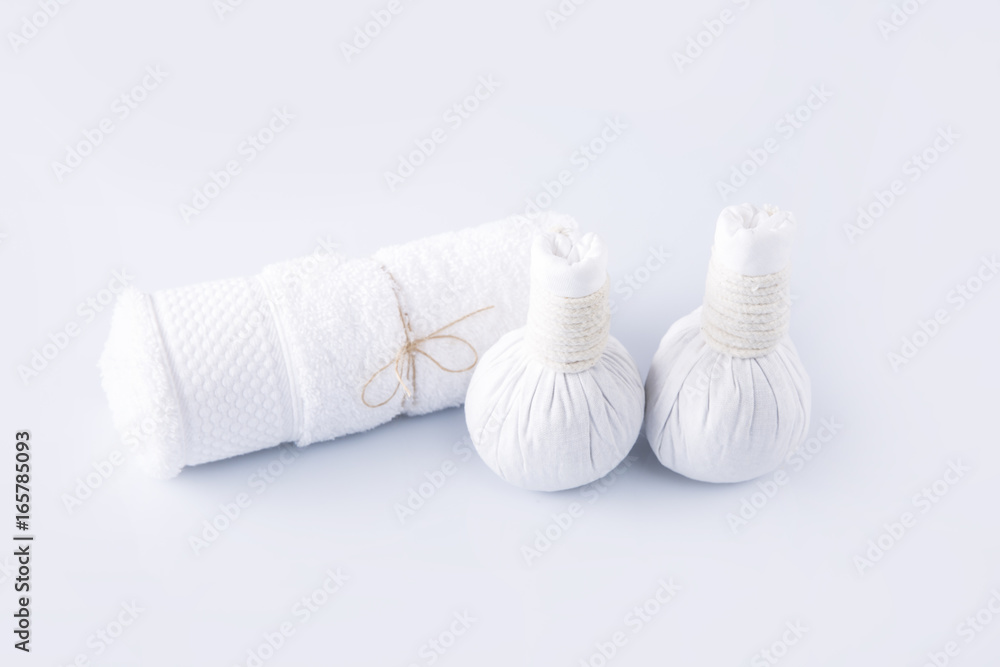 White towel and herbal balls on a white background White towel and herbal balls on a white background