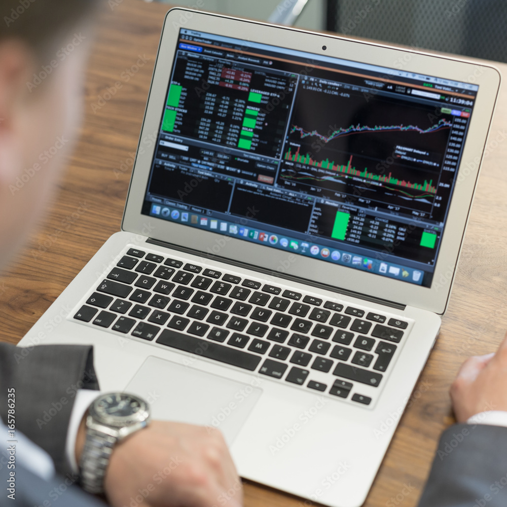 Corporate businessman analyzing economic data on laptop computer. Man's hands on notebook computer, business person at workplace. Corporate businessman analyzing economic data on laptop computer. Man's hands on notebook computer, business person at workplace.