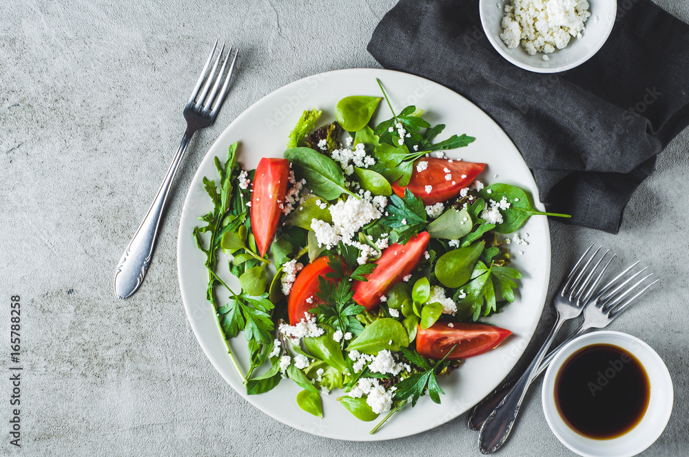 Fresh tomato salad in a grey ceramic plate. Diet or clean eating concept Fresh tomato salad in a grey ceramic plate. Diet or clean eating concept