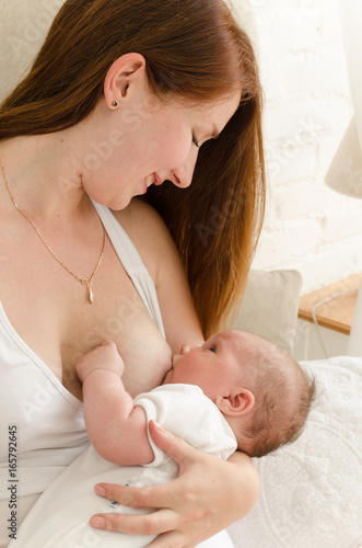 Obraz na płótnie Breastfeeding. Young mother nursing baby. Family at home w salonie