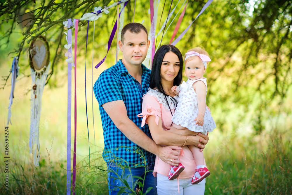 happy family walks in the evening park, amicably embrace and smile happy family walks in the evening park, amicably embrace and smile