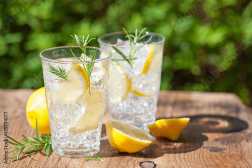 refreshing lemonade drink with rosemary in glasses photo
