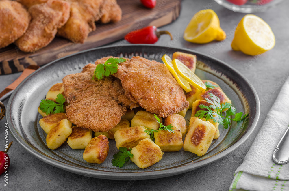 Schnitzel original with lemon and gnocchi fried Schnitzel original with lemon and gnocchi fried