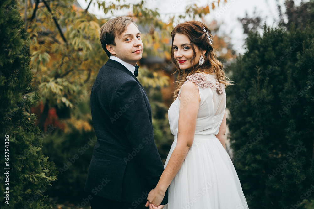 Elegant wedding couple in the autumn park