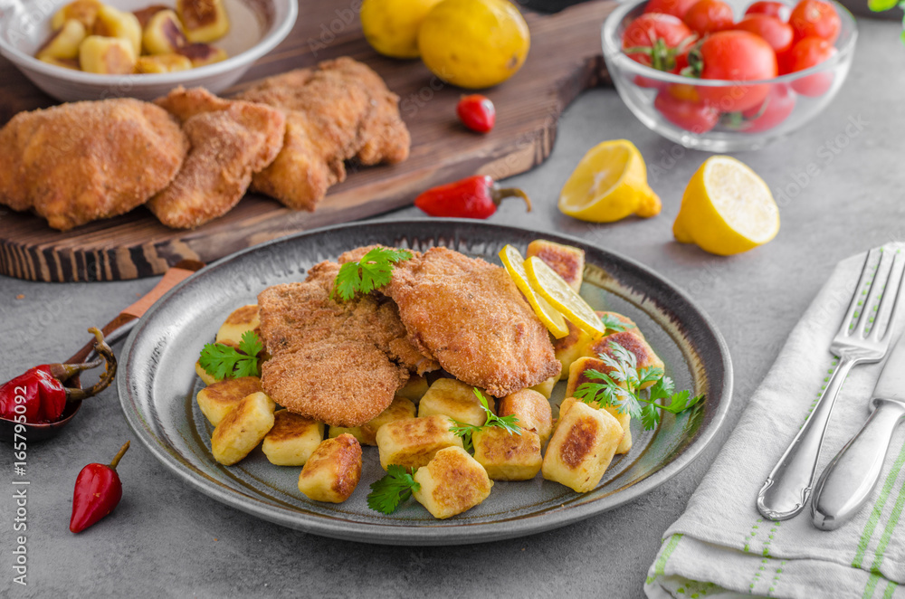 Schnitzel original with lemon and gnocchi fried Schnitzel original with lemon and gnocchi fried