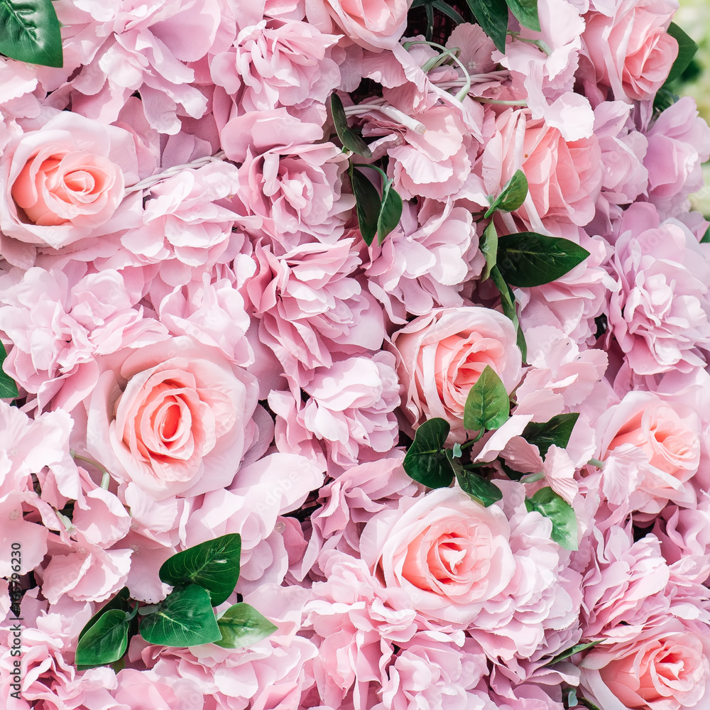 Fototapeta premium Pink fake flowers roses background. Close up, texture. Toned.