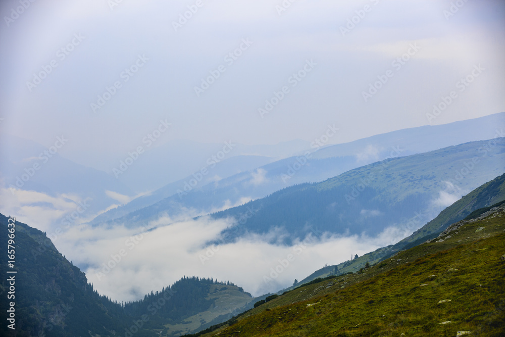 Beautiful mountain scenery with clouds above Beautiful mountain scenery with clouds above