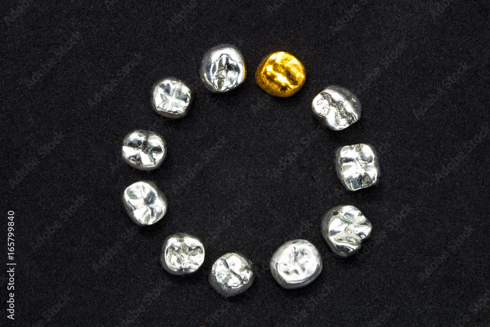 Dental gold and metal tooth crowns on dark black surface. Dental gold and metal tooth crowns on dark black surface.