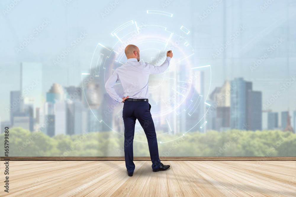 Businessman in front of a wall designing a futuristic interface - Innovation concept Businessman in front of a wall designing a futuristic interface - Innovation concept