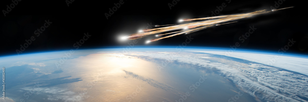 A meteor streaks towards a collision with Earth as it breaks up over the ocean.  Clouds cover an ocean area of the planet.