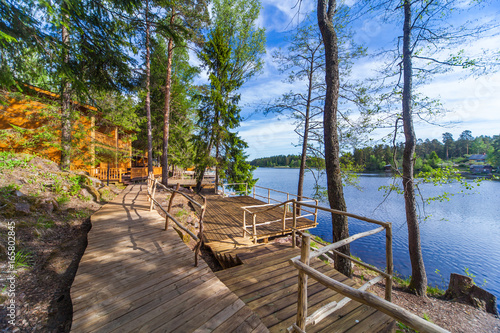 Wooden paths near the lake in the spring forest of Karelia