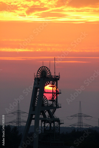 Förderturm der Zeche Ewald im Ruhrgebiet bei Sonnenuntergang photo