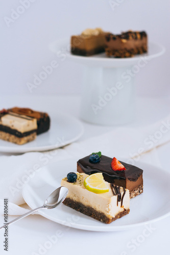 Assortment of useful raw desserts, with dried fruits and nuts on a white background