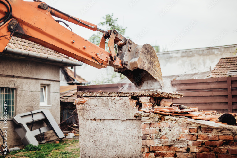 close up details of backhoe excavator scoop demolishing ruins, destroying and loading debris