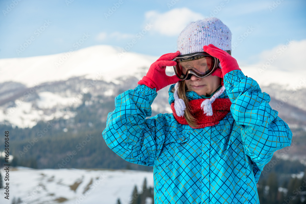 Portraite of sport woman in snowy mountains