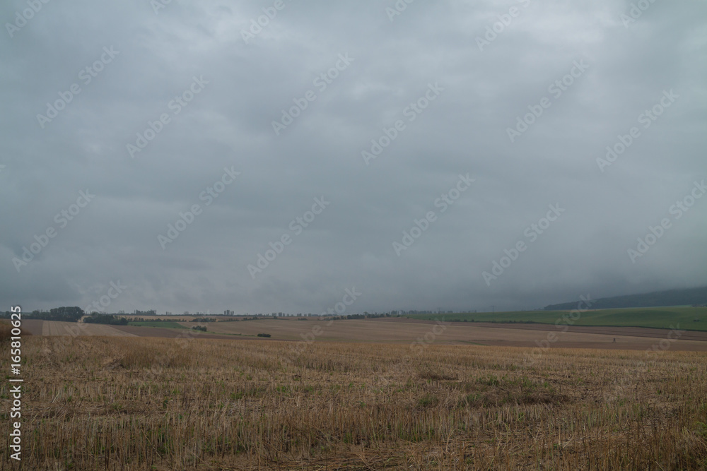 Fototapeta premium Regenwolken über geerntetem Feld