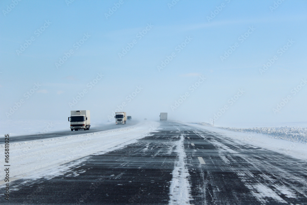 Winter road and snowdrifts on the motorway