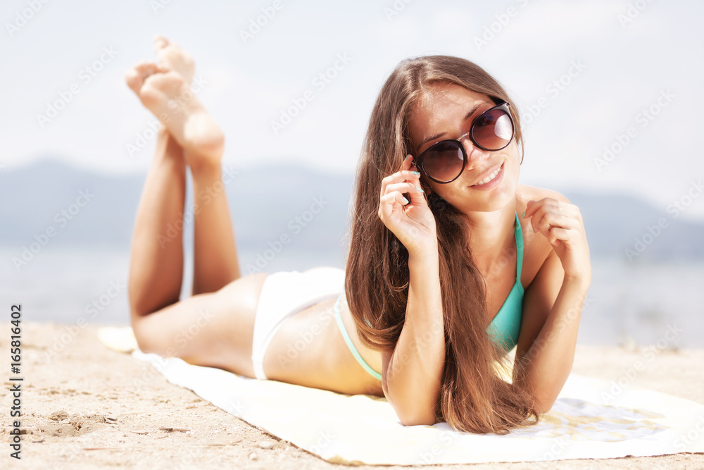 Fototapeta premium girl sunbathing on a beach