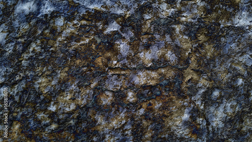 Rough yellow stone texture with black inclusions. Raw rocky mineral background