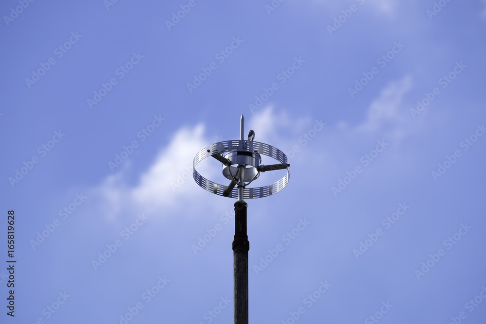 Televisions antenna with blue sky background.