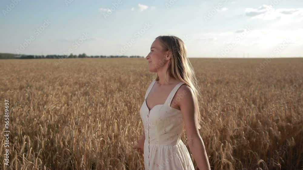Blissful beautiful woman walking in cereal field Blissful beautiful woman walking in cereal field