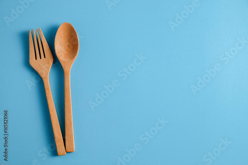 Wooden spoon on blue background, for background menu food
