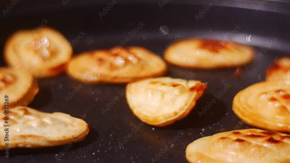 Small Round Breads Are Fried in a Frying Pan Small Round Breads Are Fried in a Frying Pan