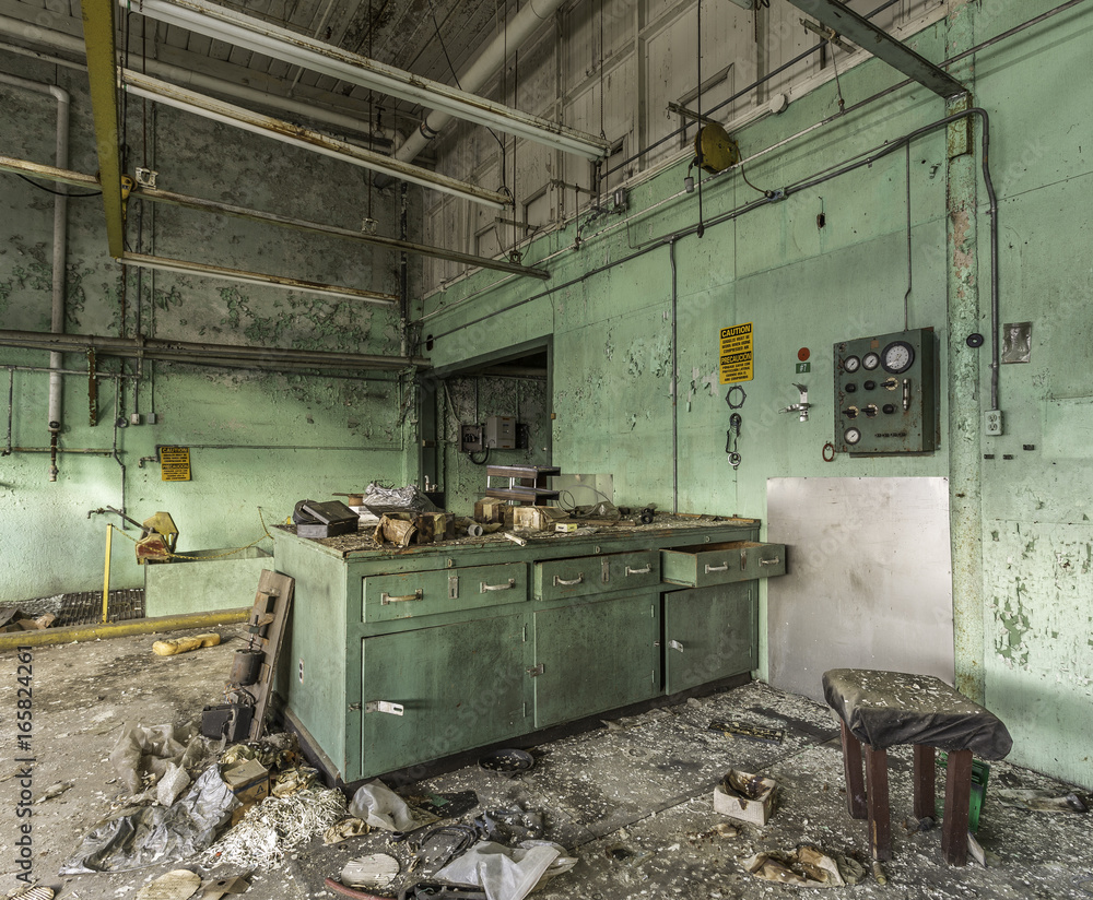 Green abandoned laboratory in an empty factory