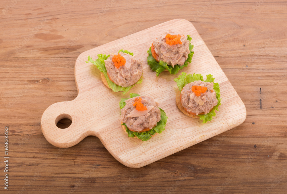 tuna salad with cracker on wooden background tuna salad with cracker on wooden background