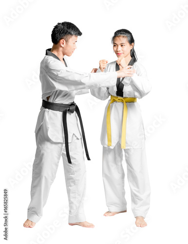 Portrait of an asian man professional taekwondo black belt degree (Dan) teaching to woman's yellow belt degree. Isolated full length on white background with copy space and clipping path