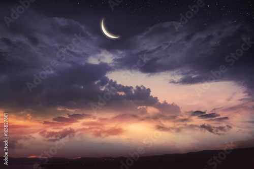  Prayer time .  Dramatic nature background .    Red sunset and moon .  Ramadan background . Arab night   . Prayer time       