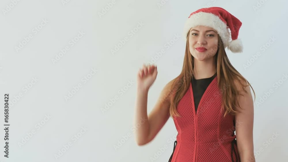 Cute girl in santa's hat counting to five on hand at white background Cute girl in santa's hat counting to five on hand at white background